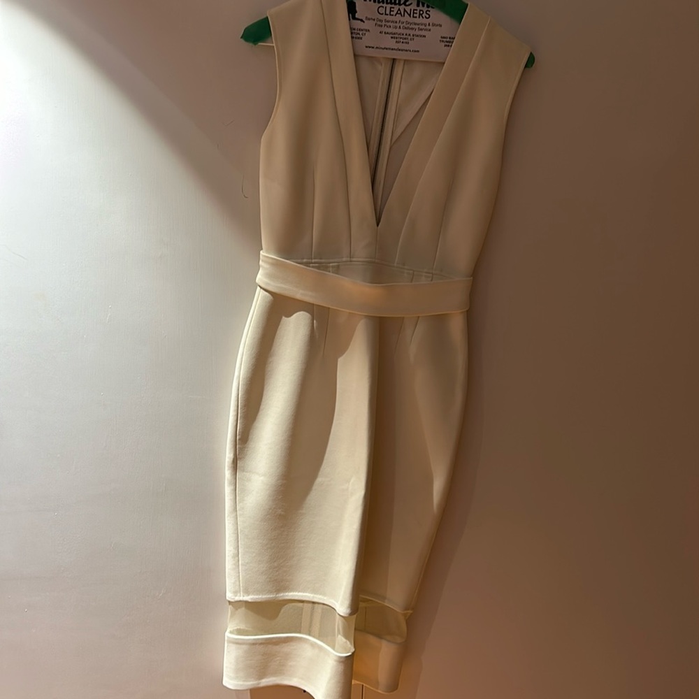 White fitted and sleeveless midi dress with deep V and belt